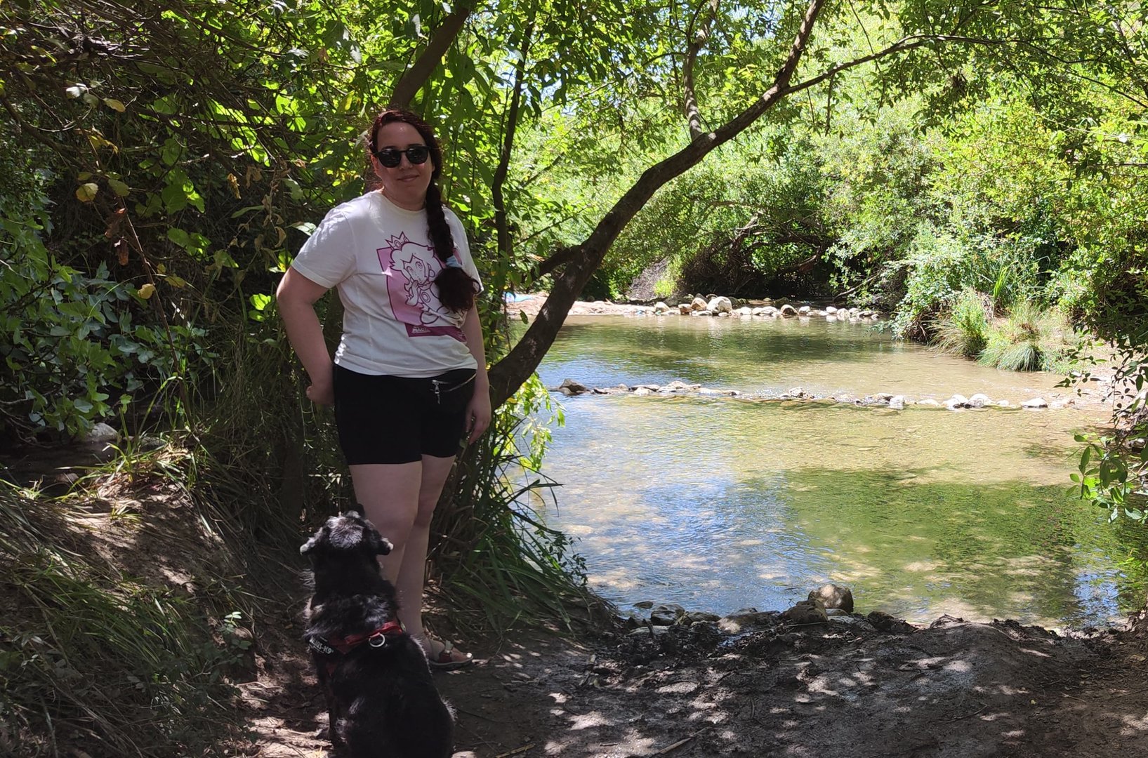 María in a river with her dog