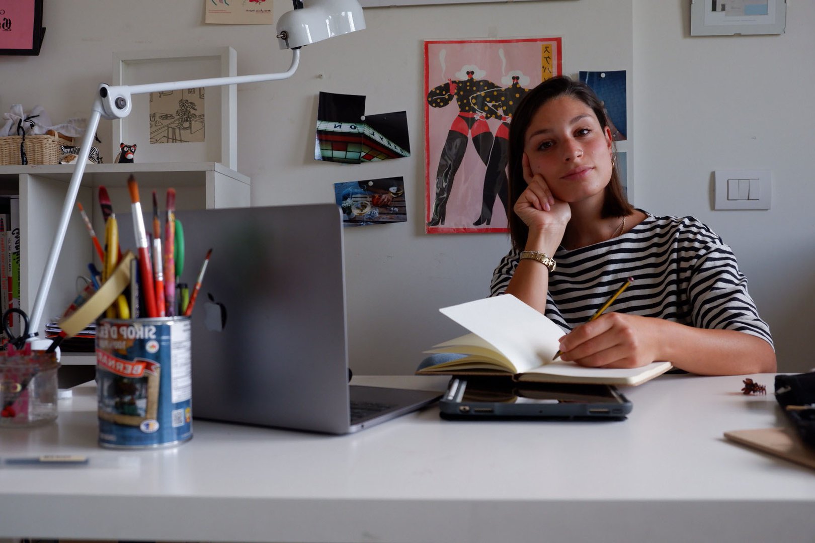 Elena, writing at her desk